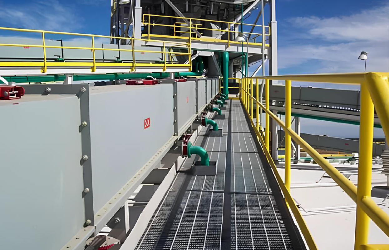 Industrial conveyor system with yellow railings and conveyor belts