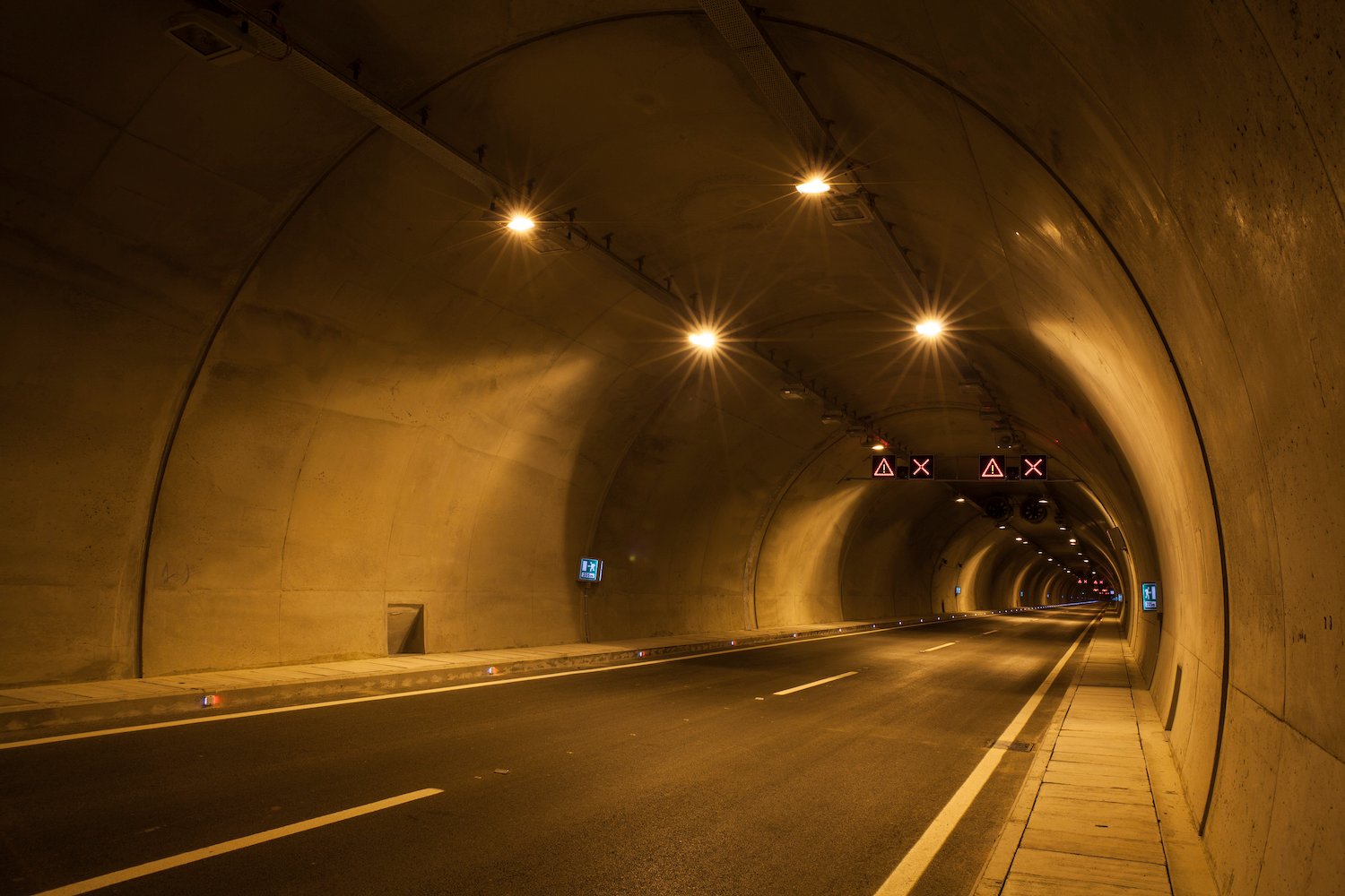 Empty highway tunnel with lights