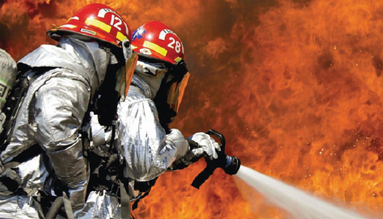 Firefighters in silver suits fighting flames