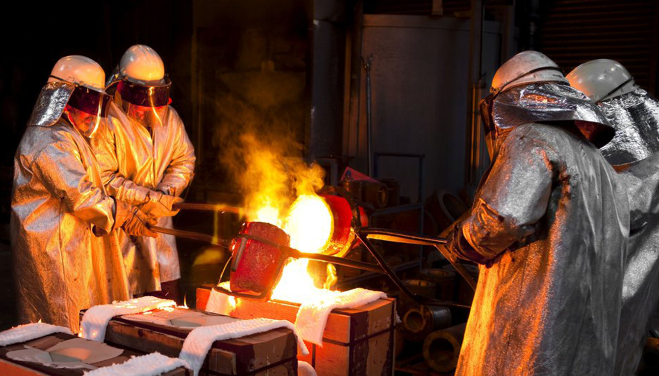 Workers pouring molten metal into molds